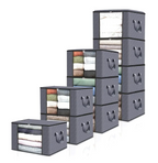Set of gray storage cubes with folded clothes inside on a white background